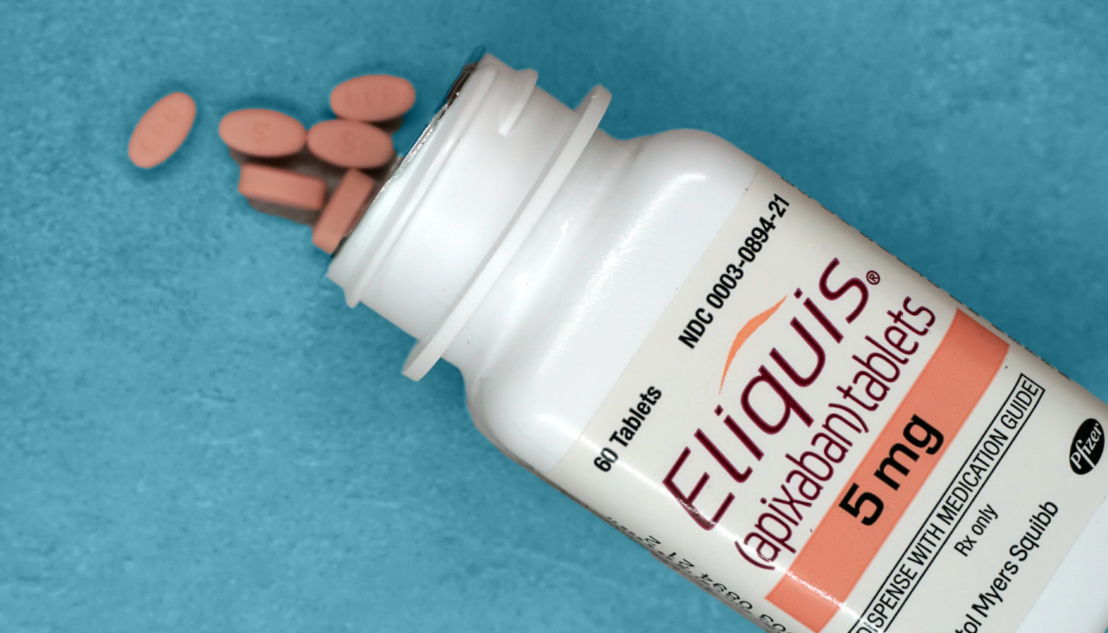 Prescription bottle of Eliquis 5 mg with spilled tablets